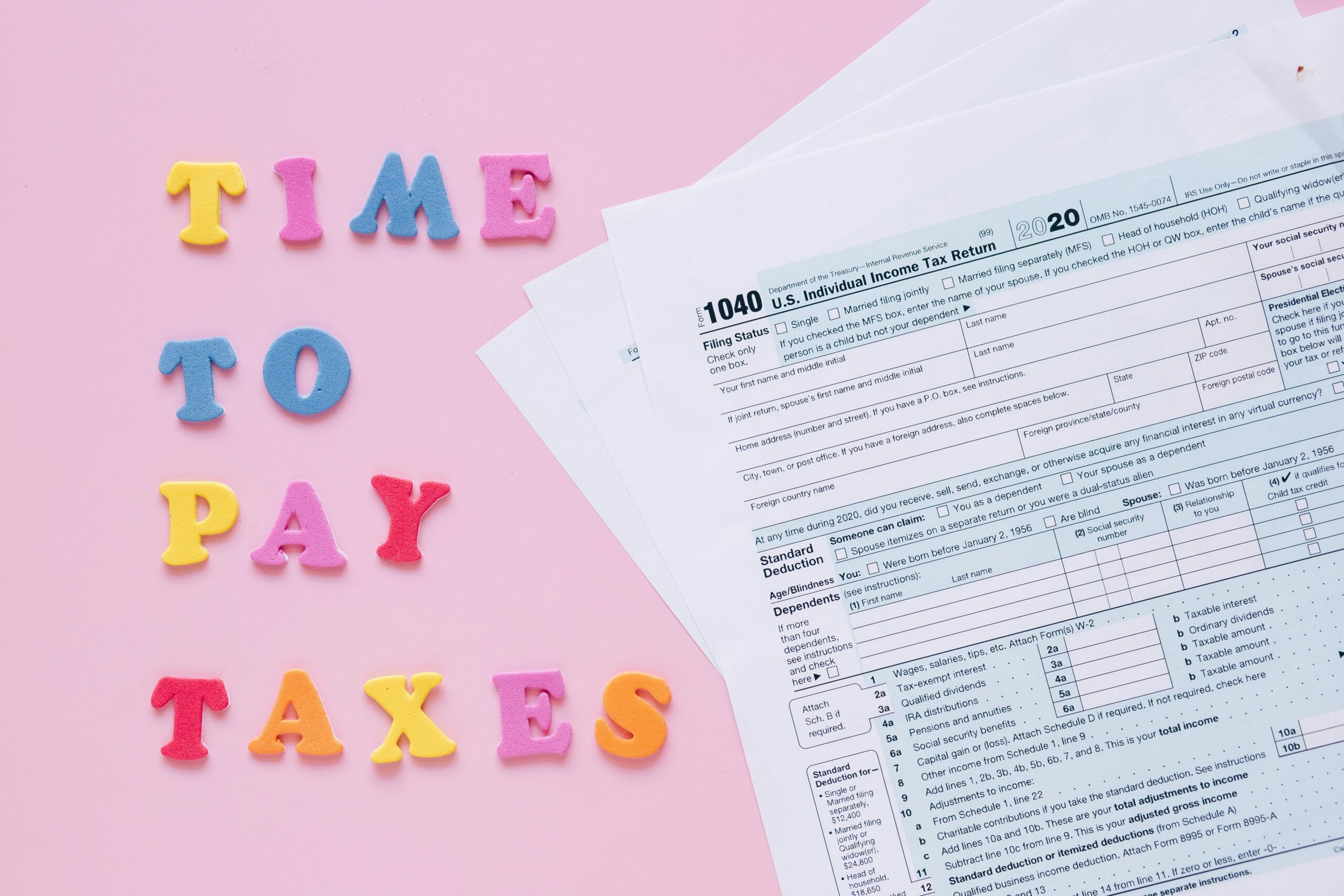 1040 tax forms with colorful 'Time to Pay Taxes' letters.